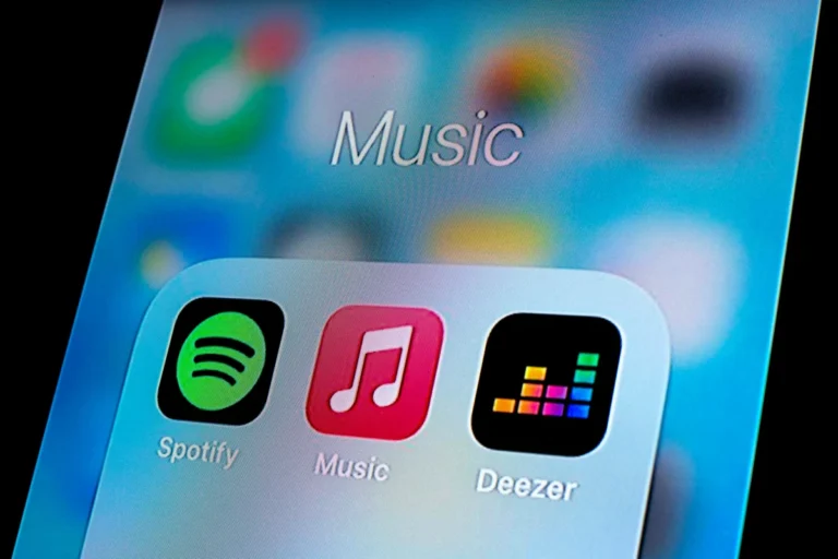 In this photo illustration, a Spotify app, Apple Music app and Deezer app are seen displayed on a smartphone.